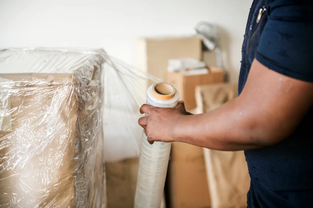 Deltona Movers Inc professional movers securely packing fragile items.