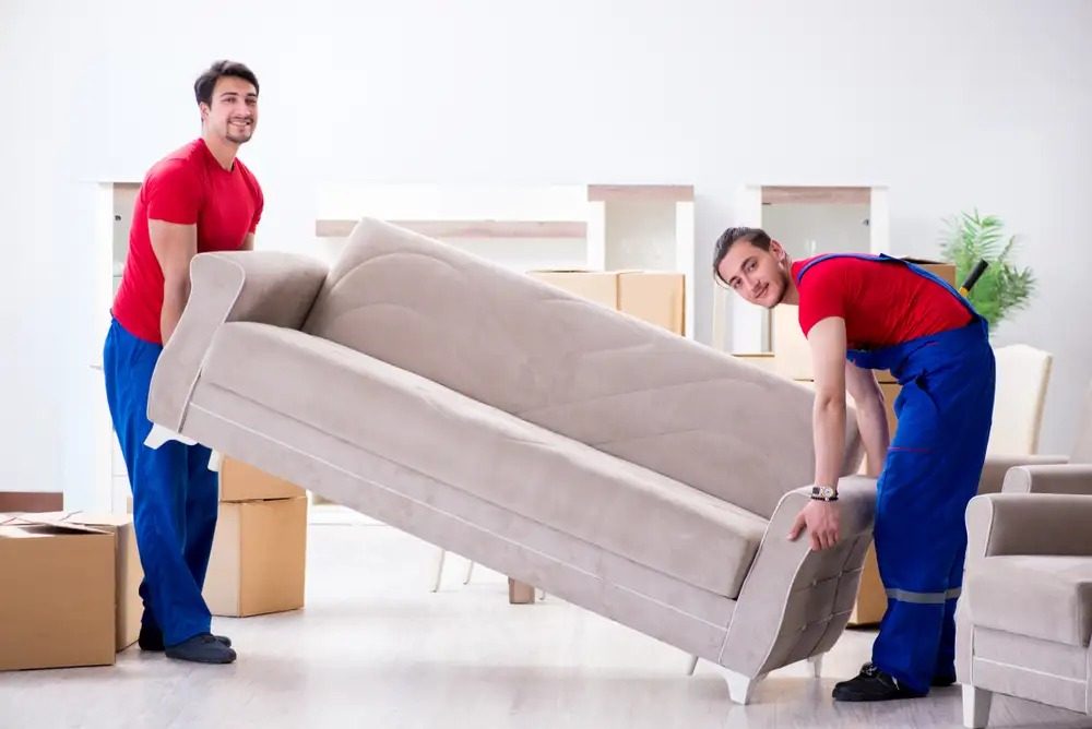 Long Distance Movers in Deltona, FL movers loading furniture to a moving truck